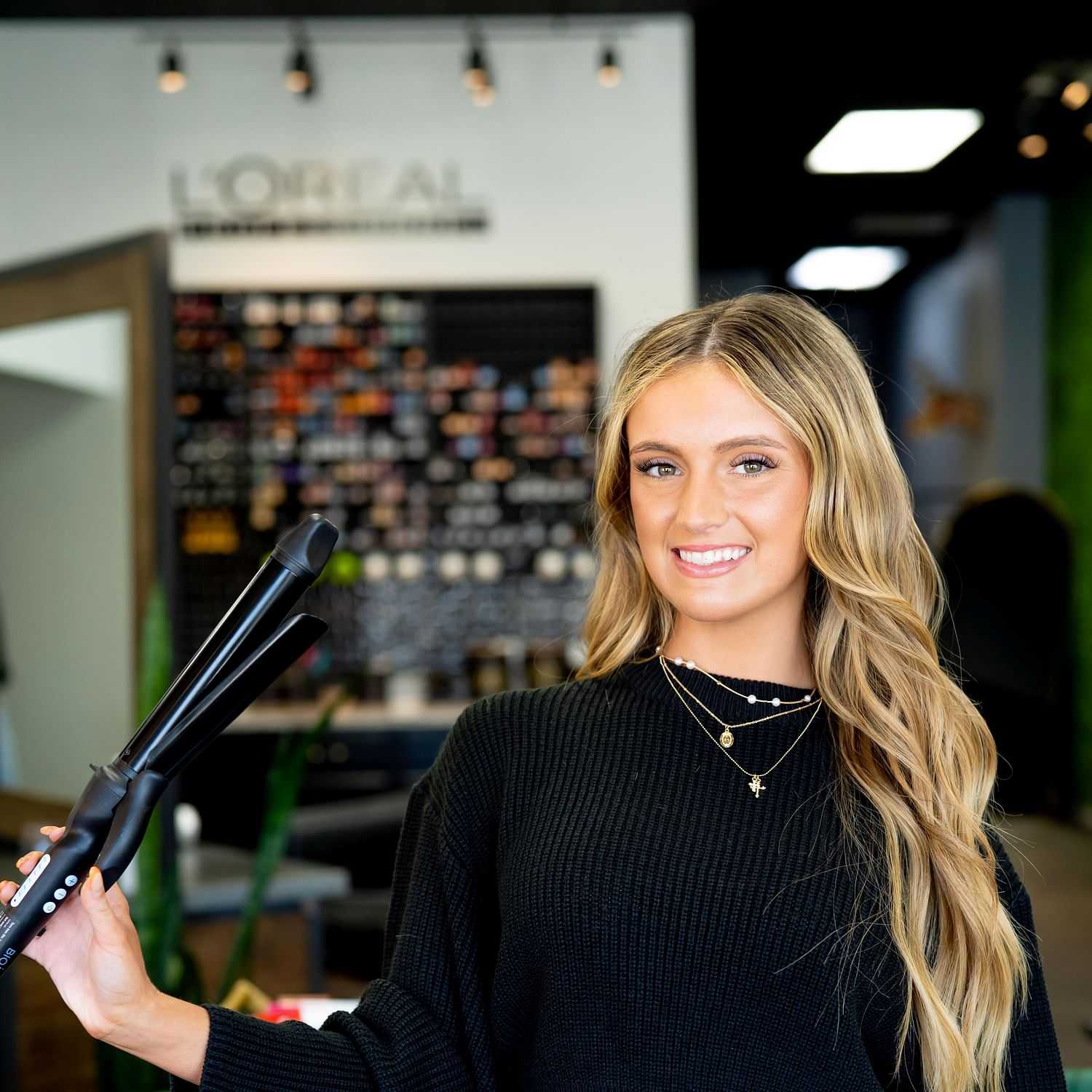 Portrait of Jenna, a professional stylist at Elevate Hair Studio by Tricia Cosgrove, showcasing their expertise and style.